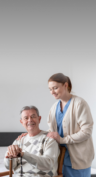 Nurse standing behind an old patient holding him