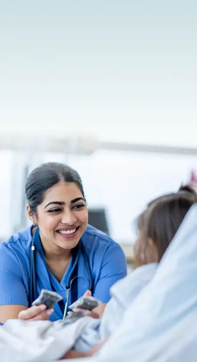 Nurse interacting with a child in a hospital room