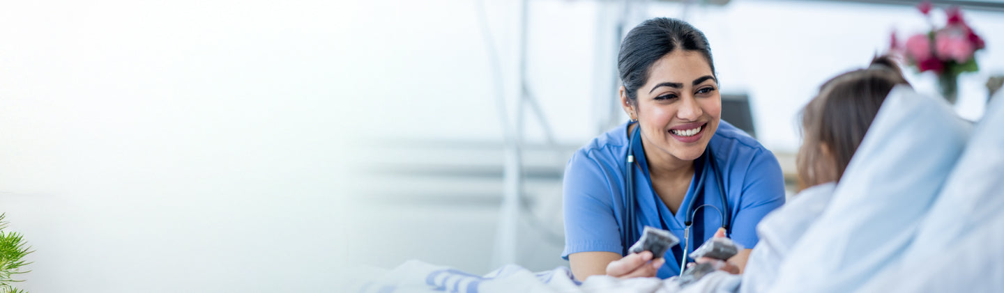 Nurse interacting with a child in a hospital room