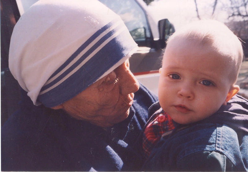 Mother Teresa embracing baby